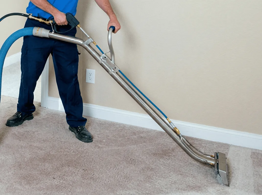 Professional operating a liquid removal machine on a carpeted floor in Philadelphia, PA